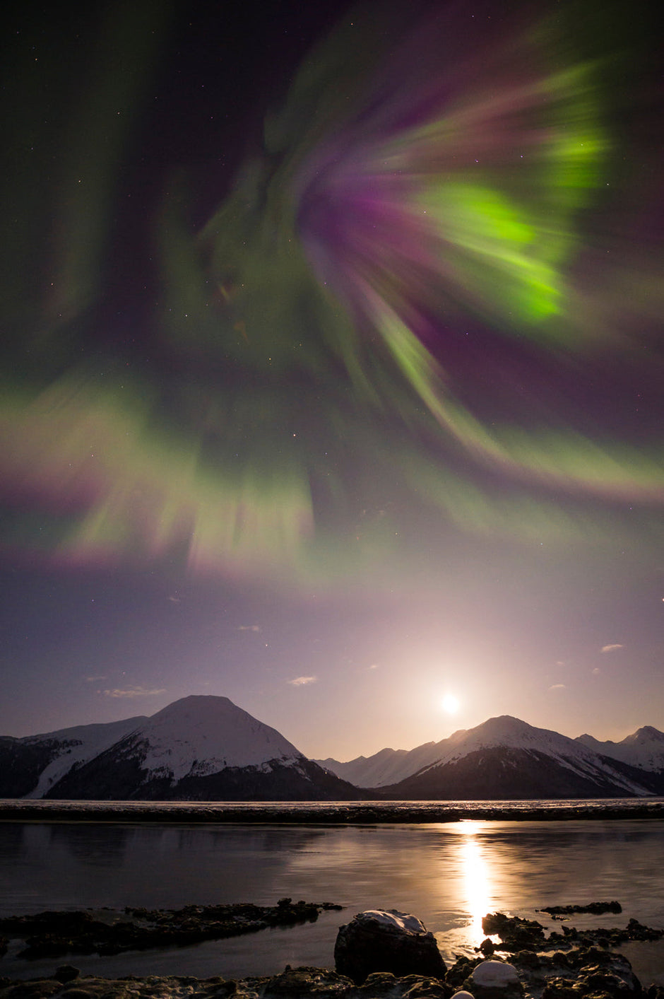 Aurora borealis over the dramatic bore tide of Turnagain Arm, Alaska
