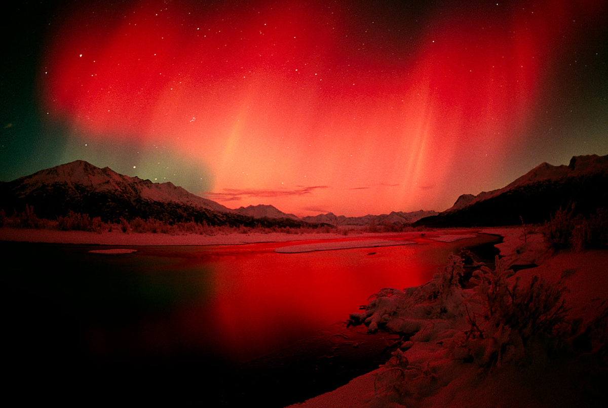 Sweeping aurora borealis landscape over Alaska's silent winter wilderness