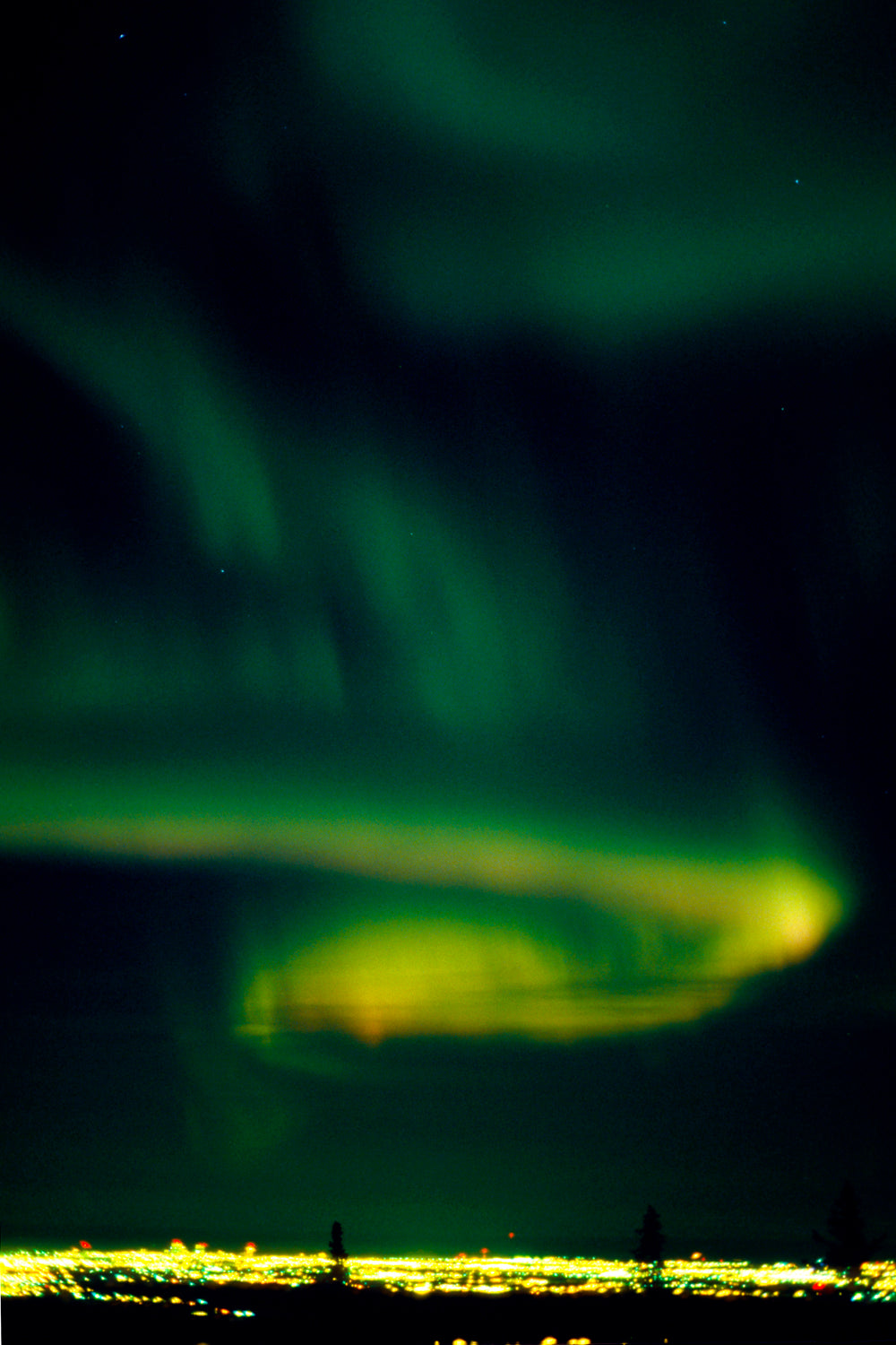 Aurora borealis resembling a glowing city of lights in Alaska's night sky