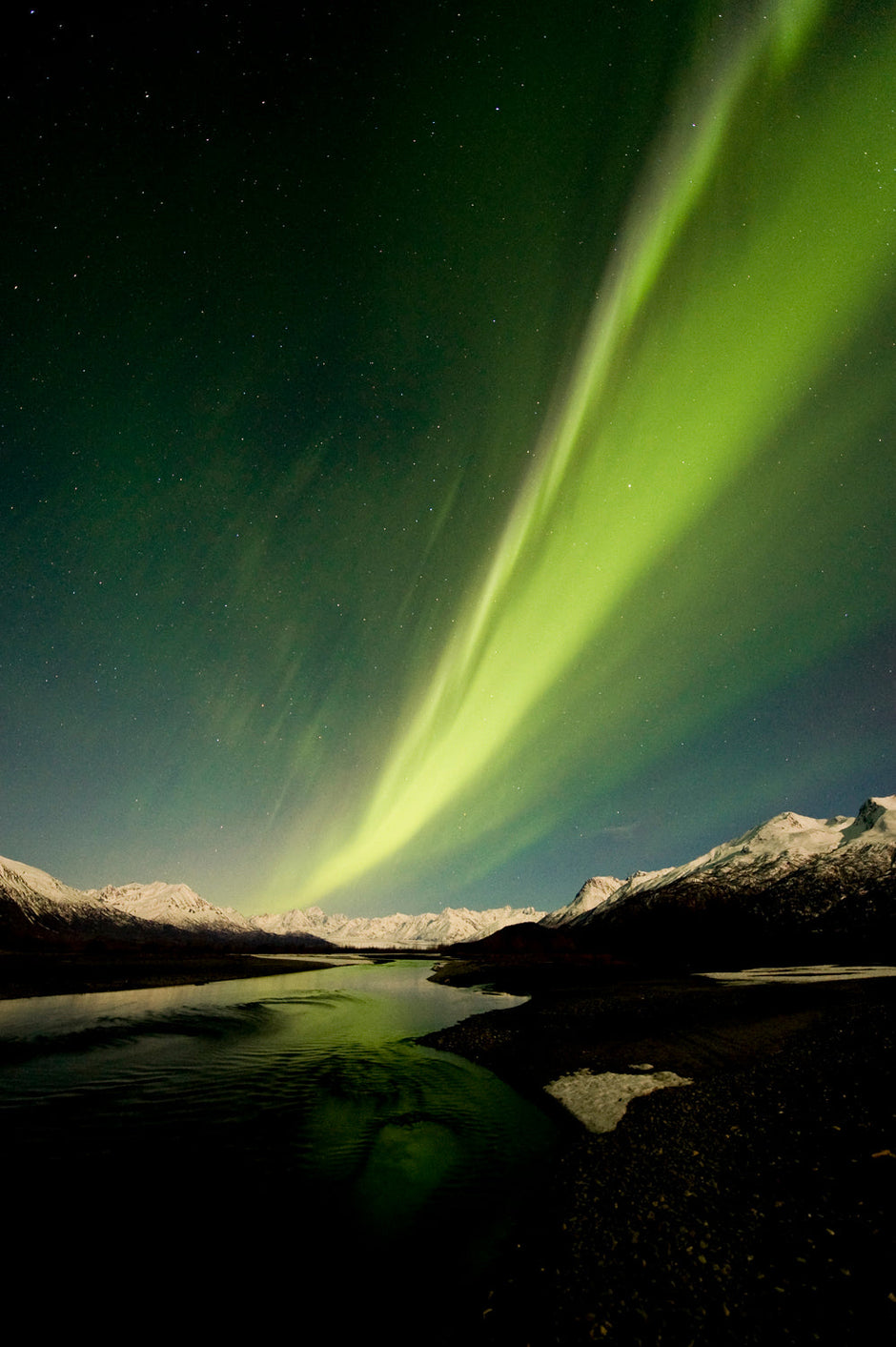Aurora borealis bridging Alaska's great divide in portrait format