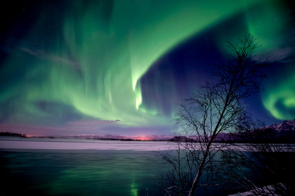 Jade green aurora borealis winds glowing over Alaska landscape