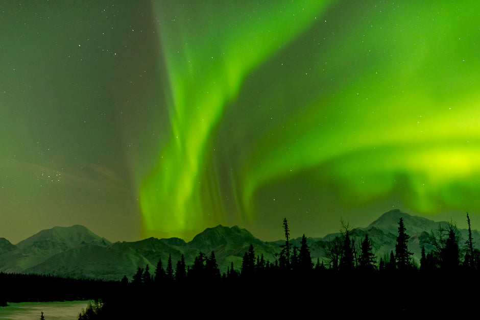 Malachite green aurora winds sweeping across Alaska landscape